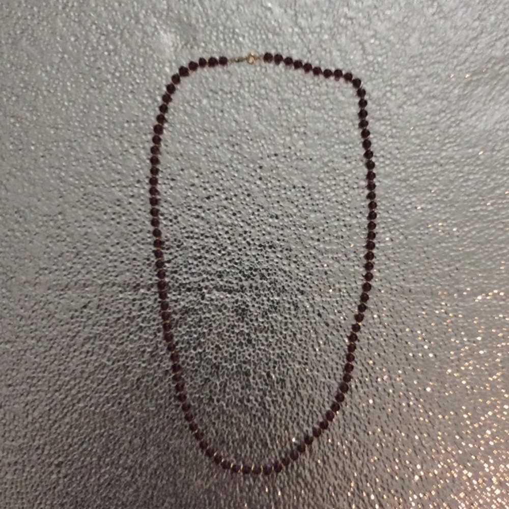 Amethyst colored necklace with gold color beads